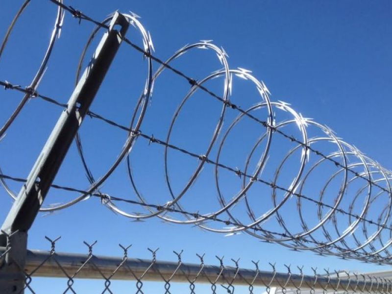 Commercial Chain Link Fence Topped with Barbed Wire in Hesperia