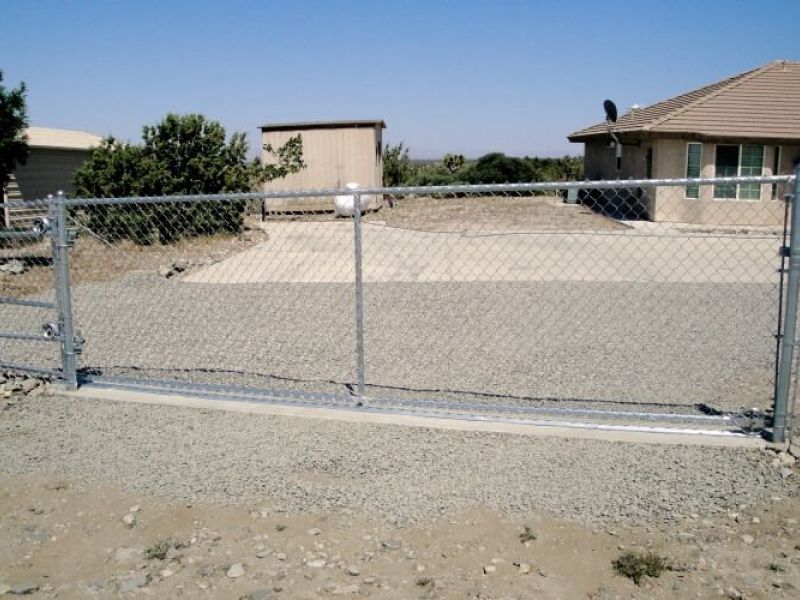 Chain link fence with a rolling driveway gate