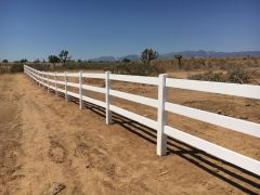 white fence on desert property near mountains