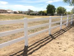 white ranch-style vinyl fence near homes