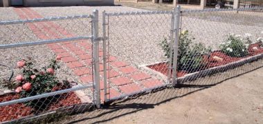 new chain link fence in front of a house) (suggested file title: new-fence