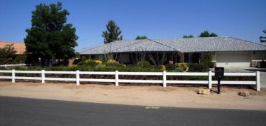 house with ranch style white vinyl fencing