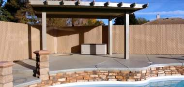 A privacy vinyl chain link fence surrounding a swimming pool