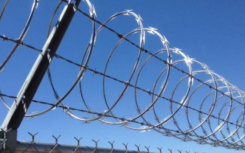 Commercial Chain Link Fence Topped with Barbed Wire in Hesperia