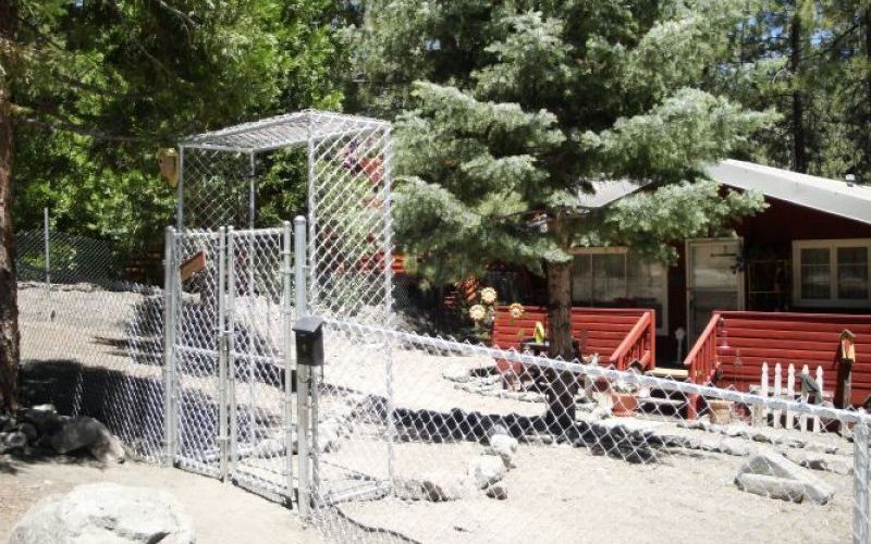 A fence for security in Wrightwood, CA, in front of a home