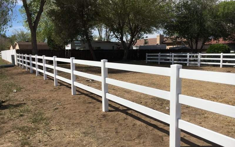 A white vinyl three-rail ranch fence installed by All American Fence Erectors in Apple Valley, CA