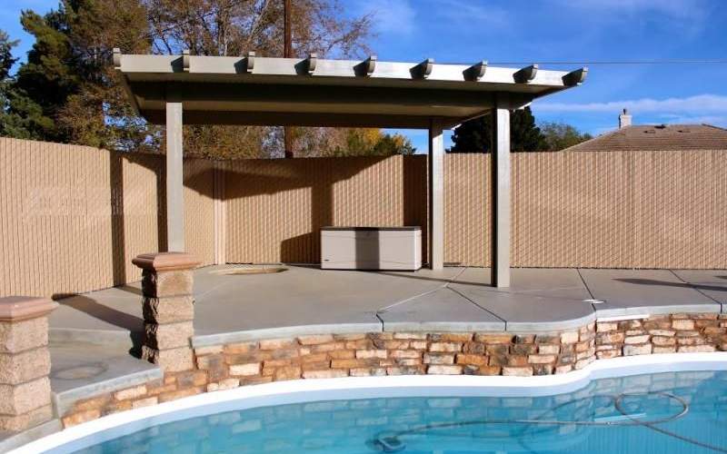 A privacy vinyl chain link fence surrounding a swimming pool