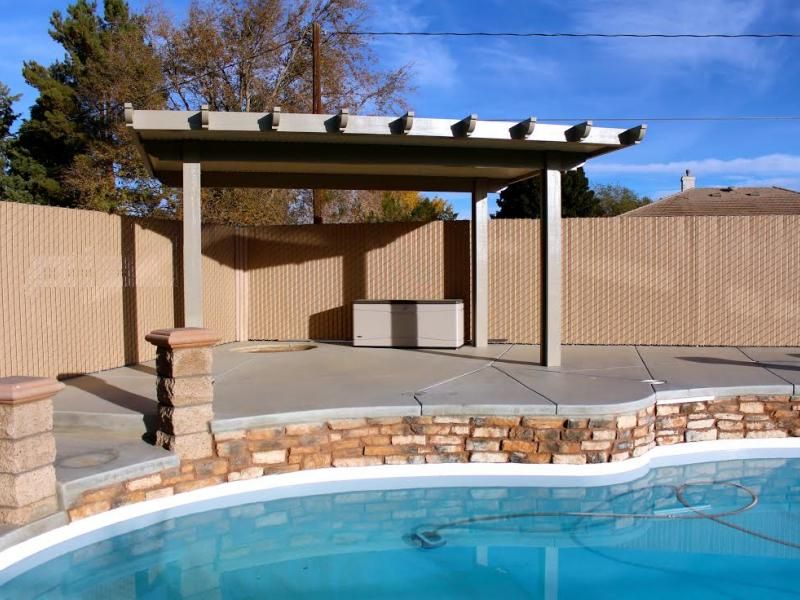 A privacy vinyl chain link fence surrounding a swimming pool
